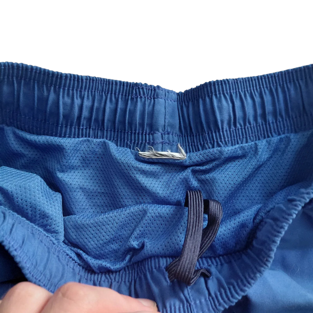 My Store blue Nike athletic shorts featuring an elastic waistband, drawstring, and breathable interior mesh lining.