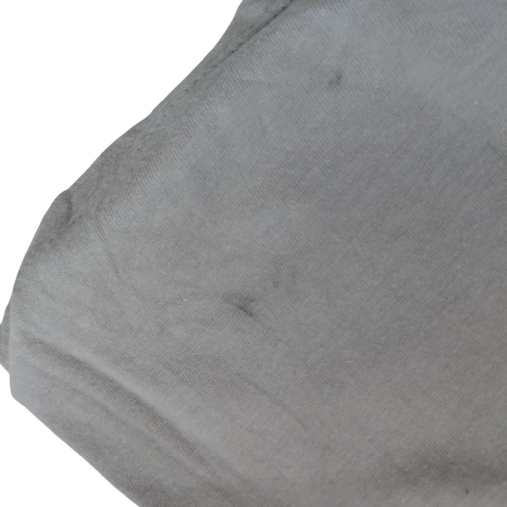 Close-up of My Store grey cotton jersey fabric showing a small dark mark on the Nike t-shirt material.