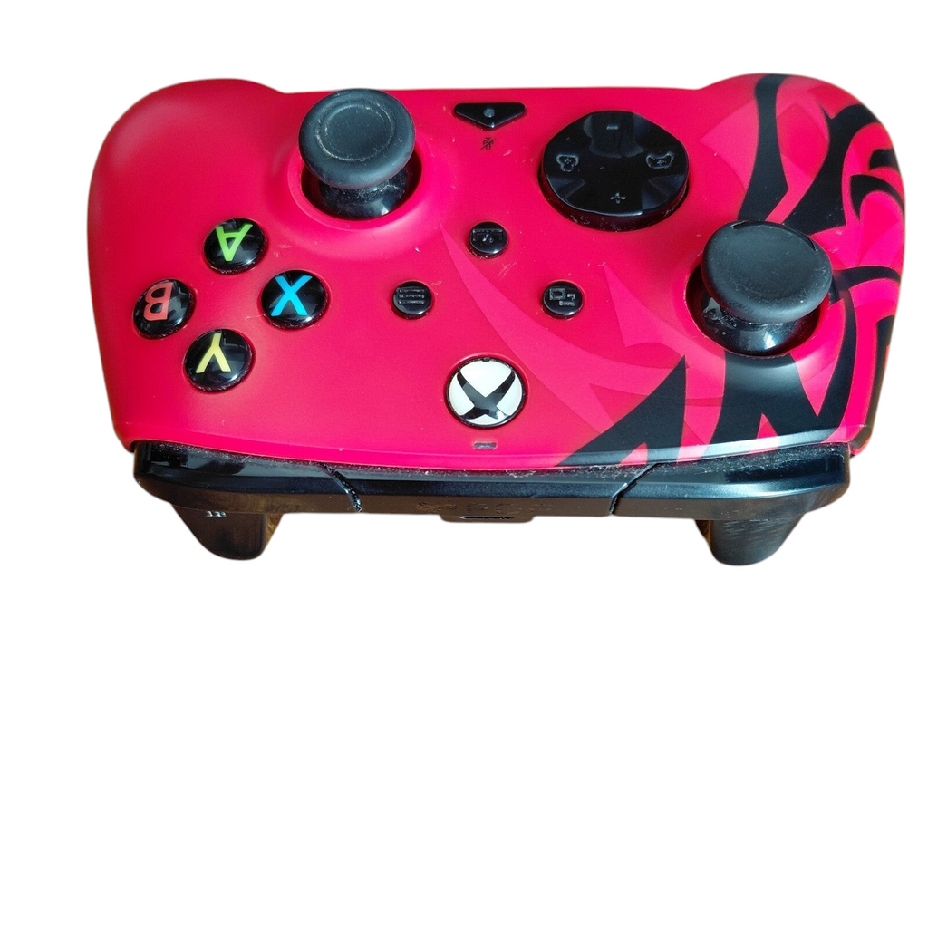 My Store PDP Xbox REMATCH Advanced Wired Controller in Spirit Red with black tribal accents on a wooden surface