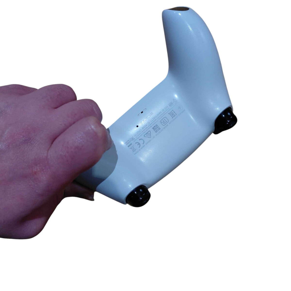 My Store white Sony DualSense PS5 controller held in hand showing the back label and triggers