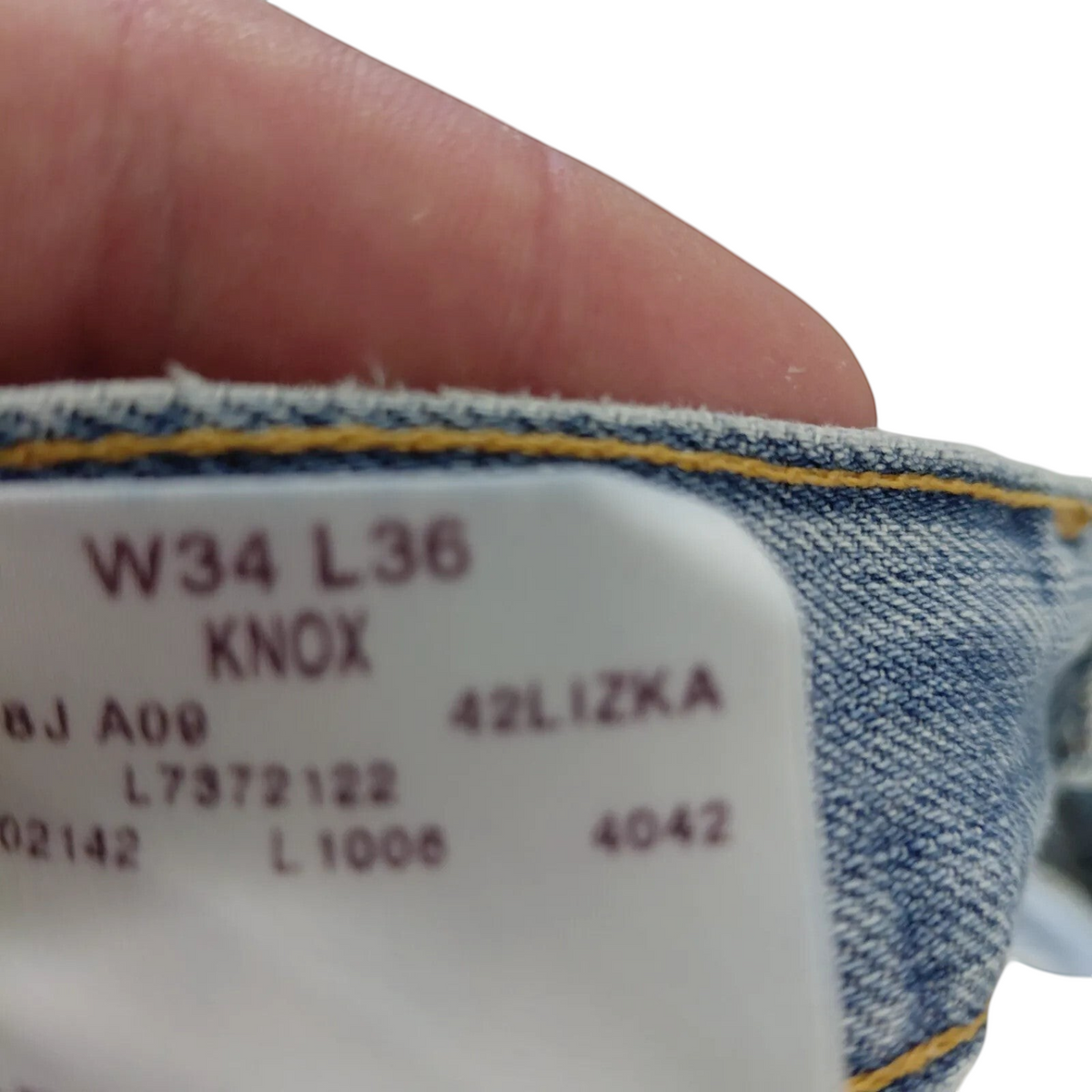 My Store Lee jeans interior size tag showing W34 L36 and Knox model details on light blue denim fabric