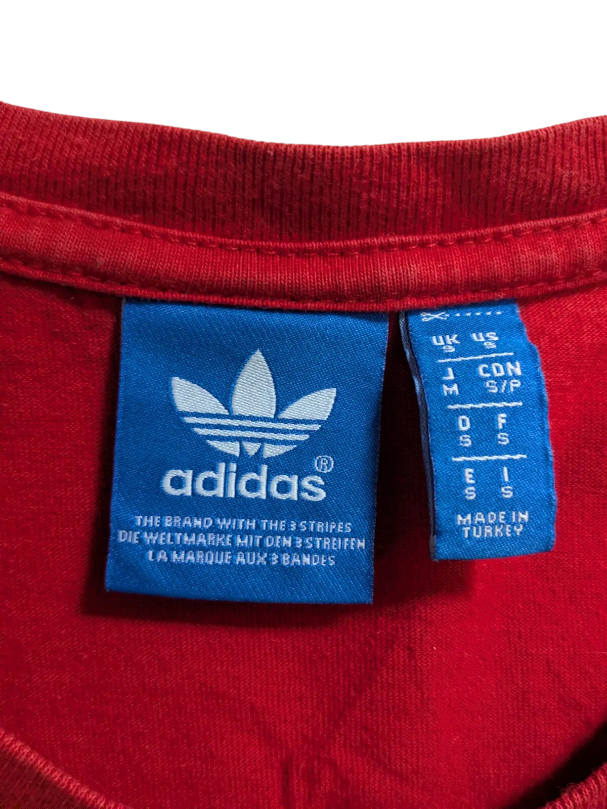 My Store red Adidas Originals cotton t-shirt interior neck label with blue trefoil logo branding