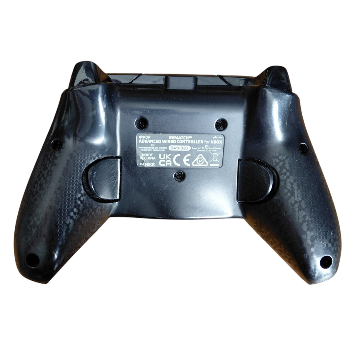 Back view of My Store PDP Xbox REMATCH Advanced Wired Controller in black with textured grips on a wooden surface.