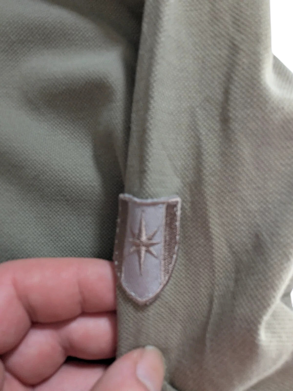 My Store khaki cotton pique polo shirt featuring a detailed embroidered logo patch on the sleeve