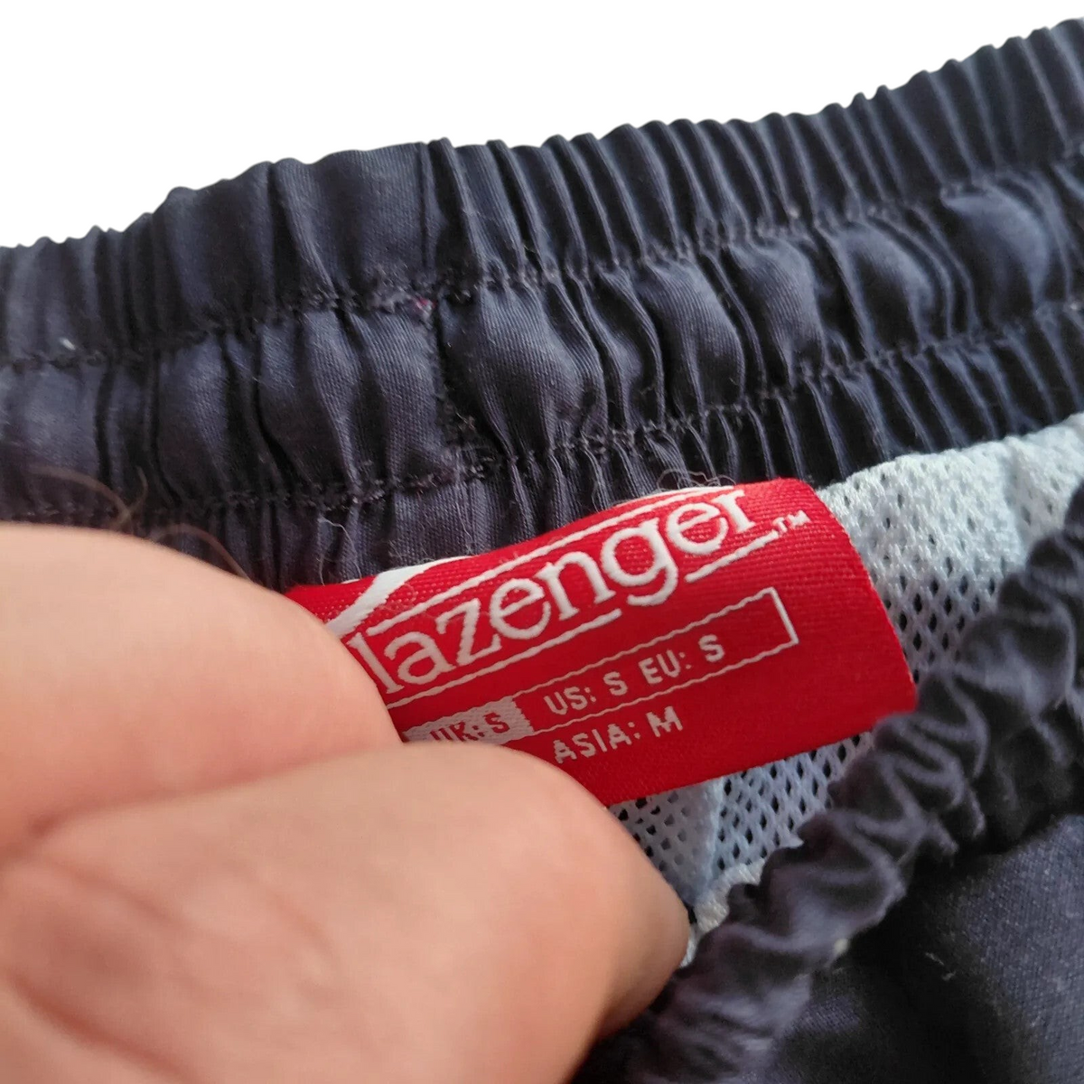 My Store Slazenger navy athletic shorts featuring an elastic waistband and white mesh lining, size small label detail