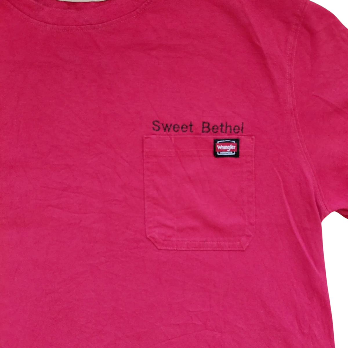 My Store pink Wrangler crew neck t-shirt with a chest pocket and Sweet Bethel graphic logo detail.