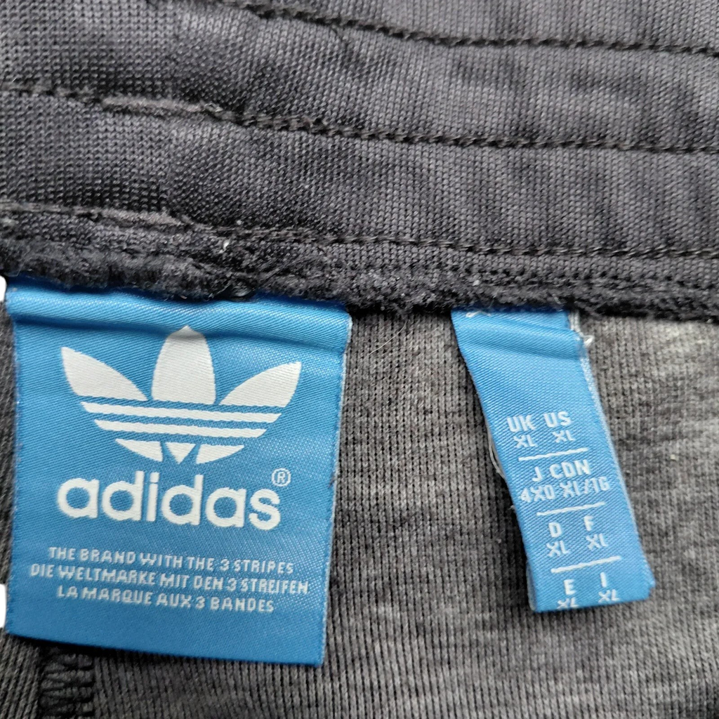 My Store Adidas black track pants size XL label with blue logo tag and size details