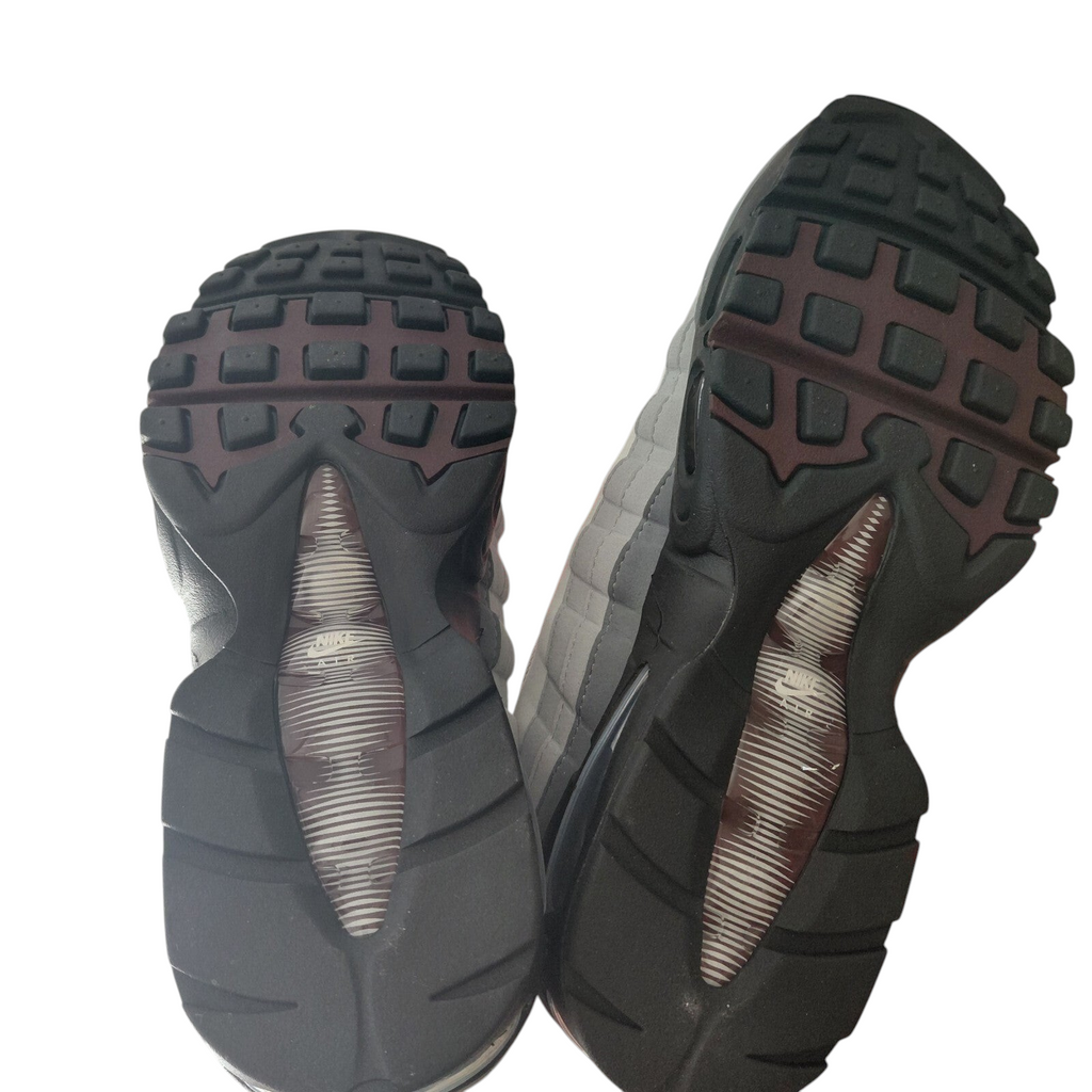 My Store Nike Air Max 95 trainers showing the black and burgundy rubber outsoles with ribbed traction patterns