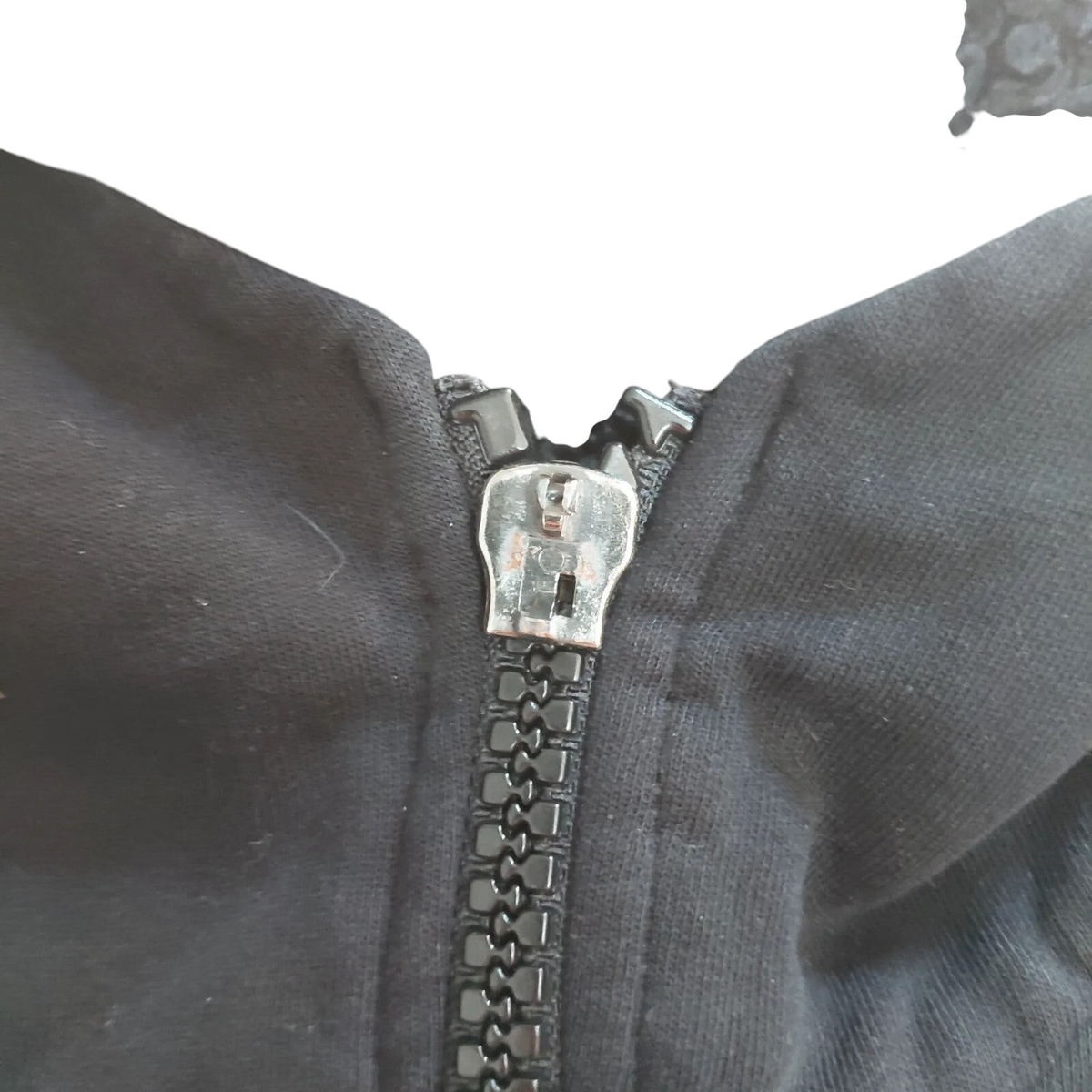 My Store black Converse zip hoodie featuring a fleece-lined interior and a close-up of the front zipper detail.