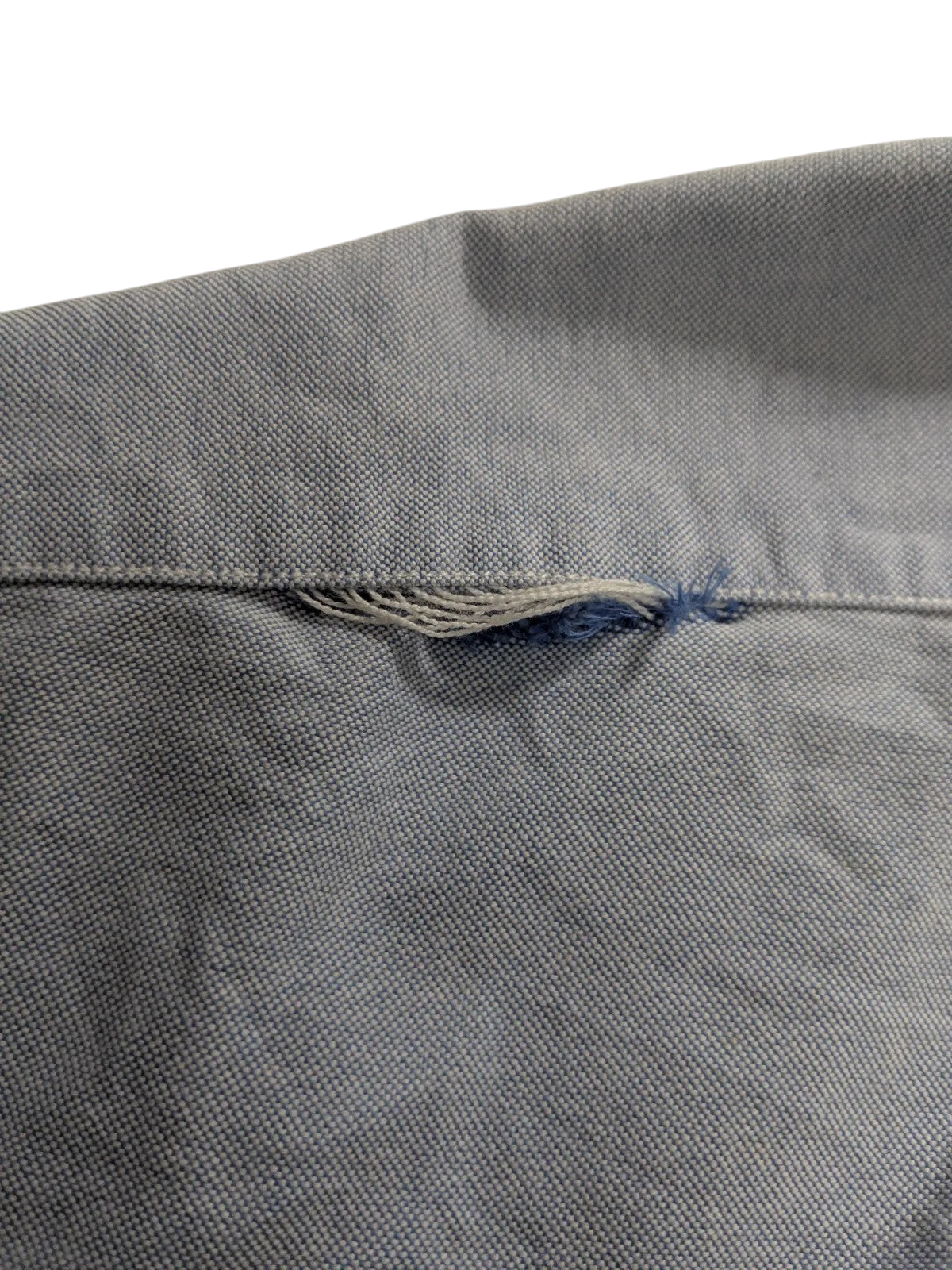 My Store Ralph Lauren light blue cotton shirt showing fraying damage on the fabric seam