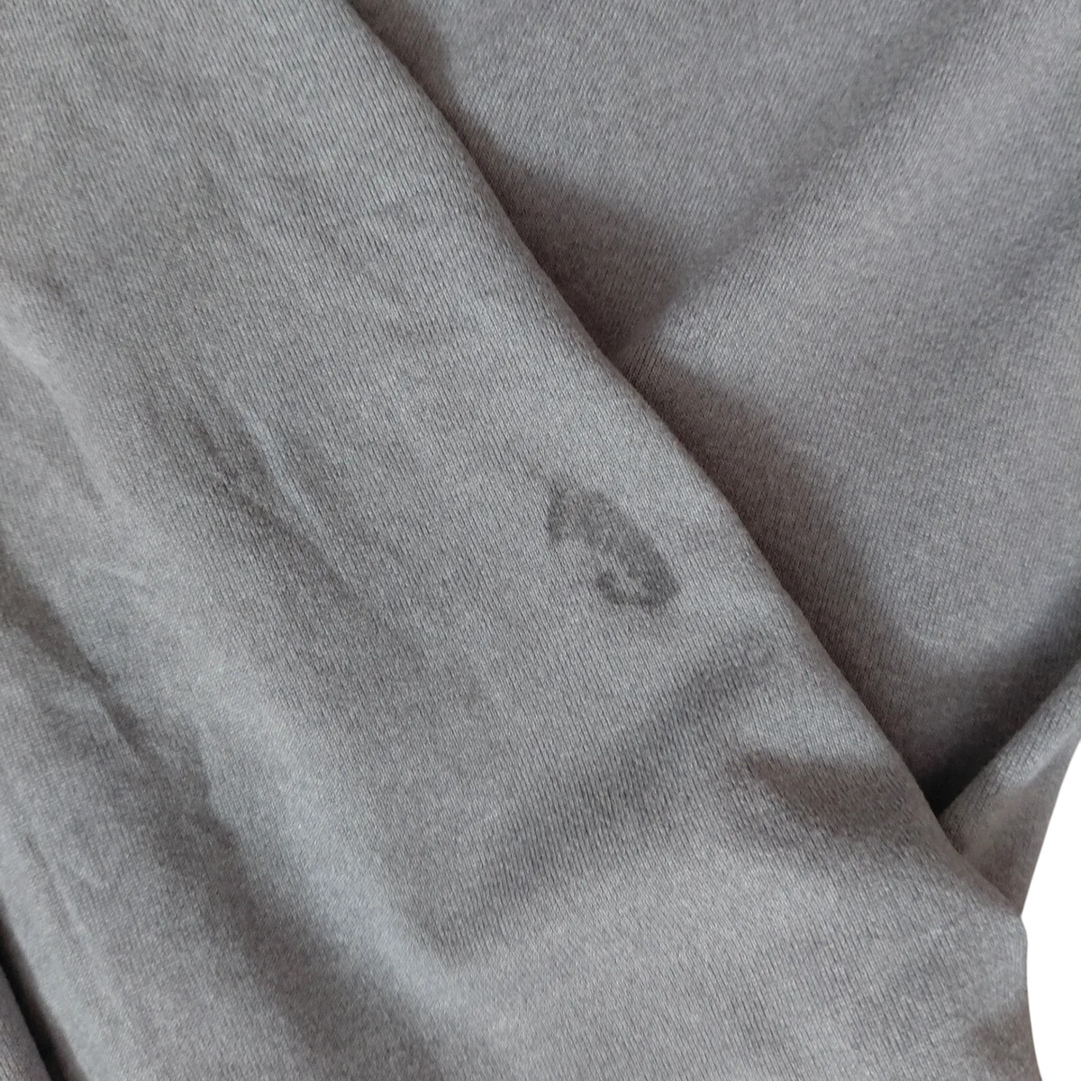 My Store grey Under Armour long sleeve t-shirt fabric detail showing a small dark mark on the material
