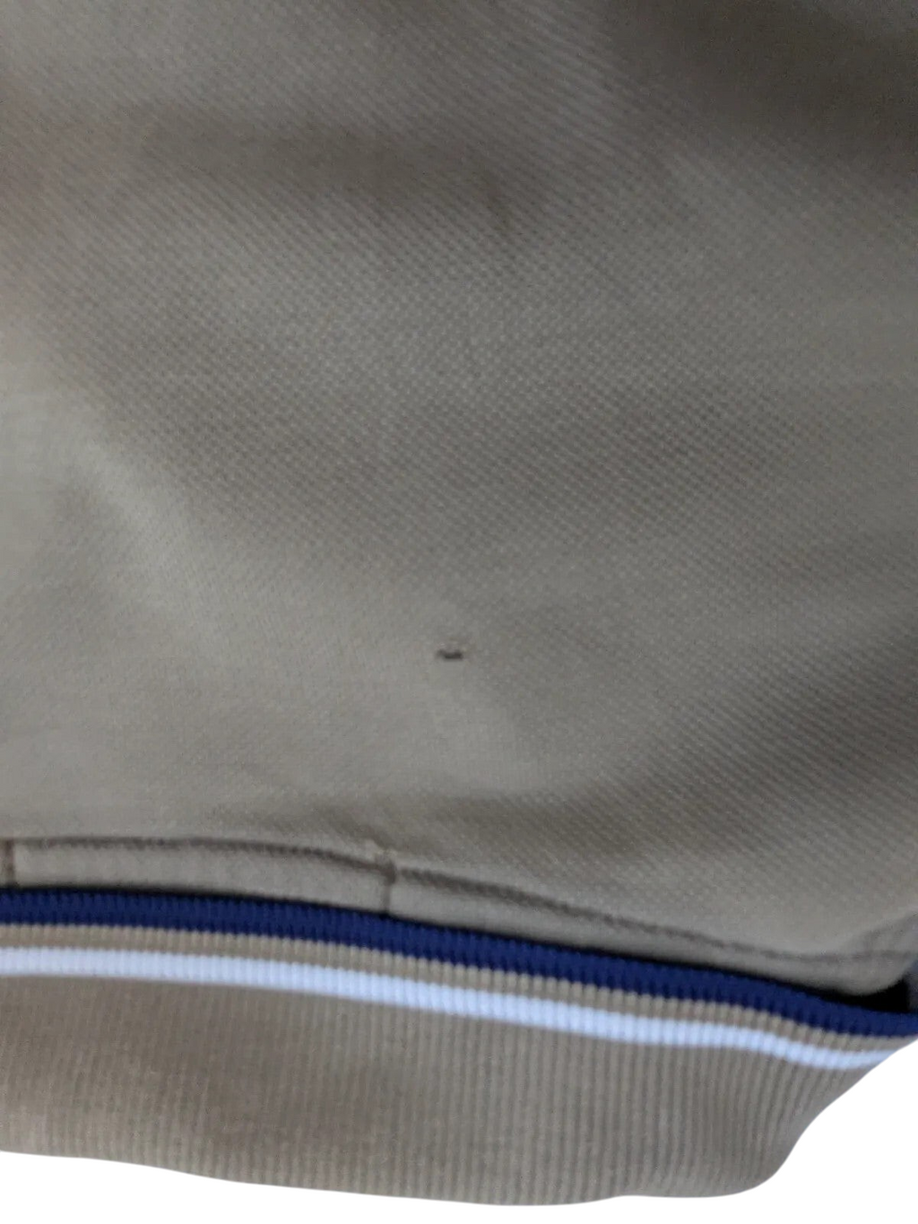 My Store khaki Fred Perry cotton pique polo shirt showing a small fabric nick near the striped collar trim