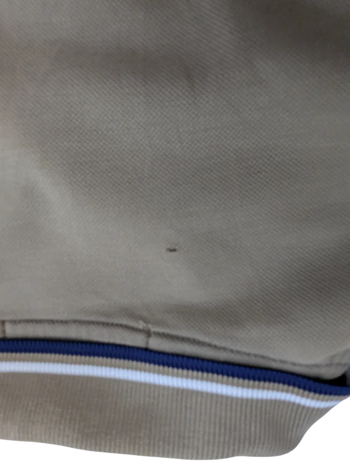 My Store khaki Fred Perry cotton pique polo shirt showing a small fabric nick near the striped collar trim