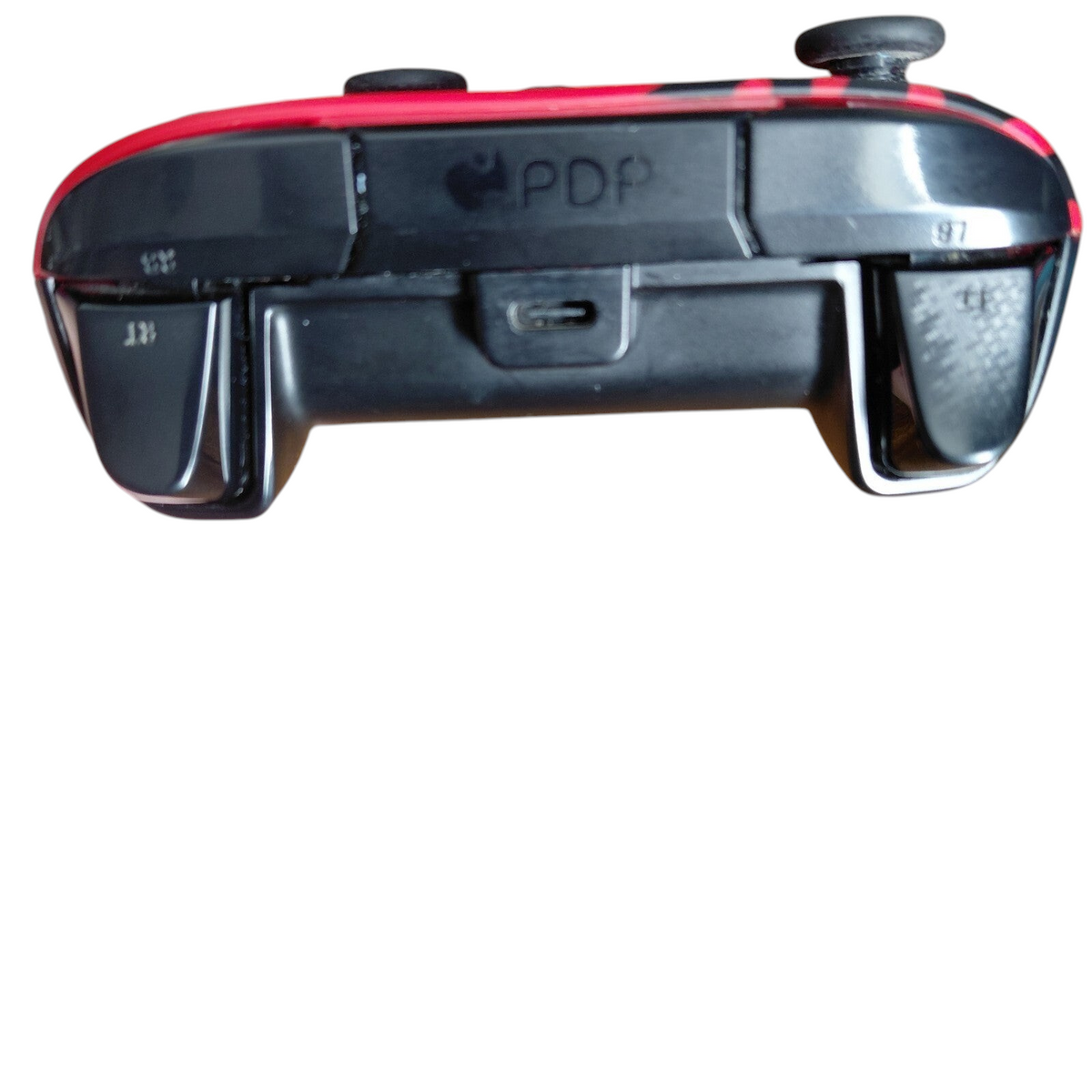 My Store PDP Xbox REMATCH Advanced Wired Controller in Spirit Red, showing the top edge with USB-C port and bumpers.