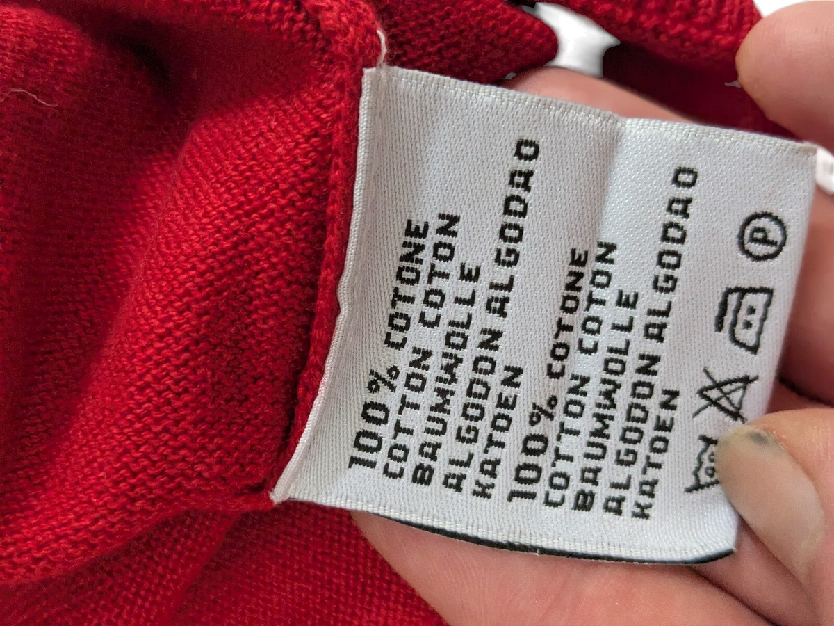 My Store Kappa red V-neck sweater fabric care label showing 100 percent cotton composition