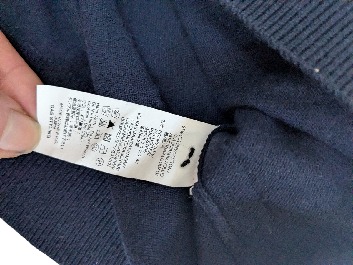 My Store navy Gas button cardigan sweater fabric care label showing cotton polyester and cashmere blend composition