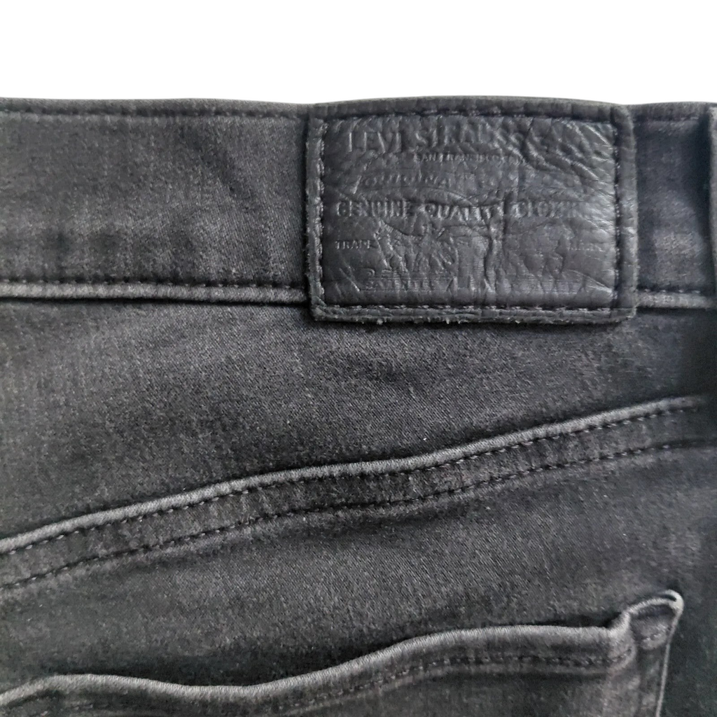 My Store Levi's 312 black denim jeans featuring a branded leather back patch and detailed stitching