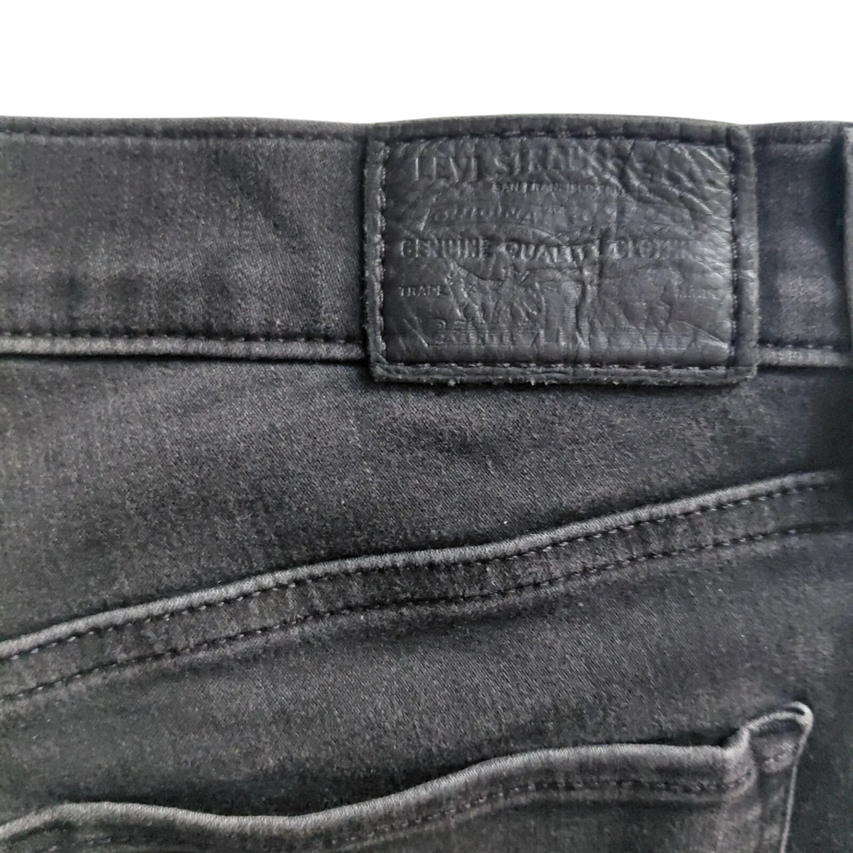 My Store Levi's 312 black denim jeans featuring a branded leather back patch and detailed stitching