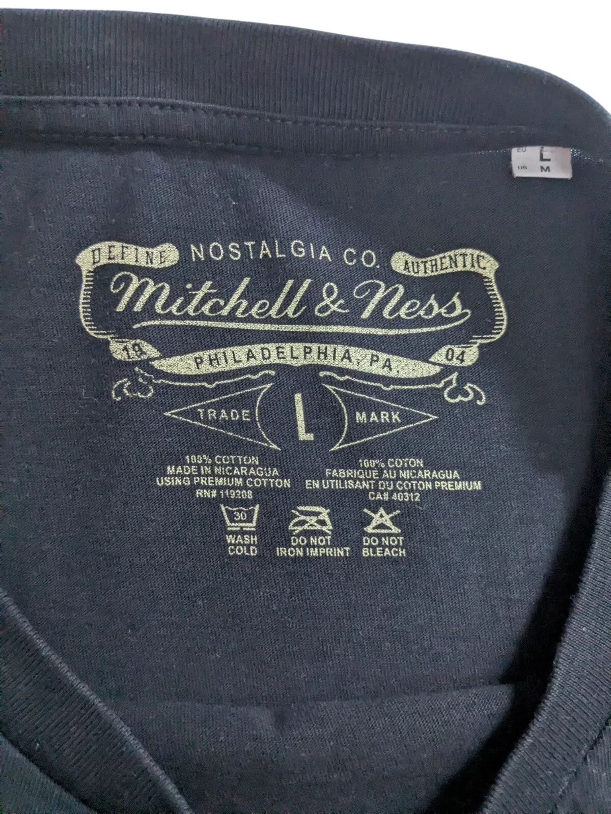 My Store Mitchell & Ness black cotton t-shirt interior neck label with size L and care instructions