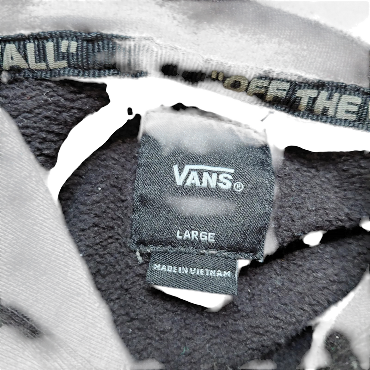 My Store Vans black pullover hoodie interior neck label showing size large and fleece lining detail