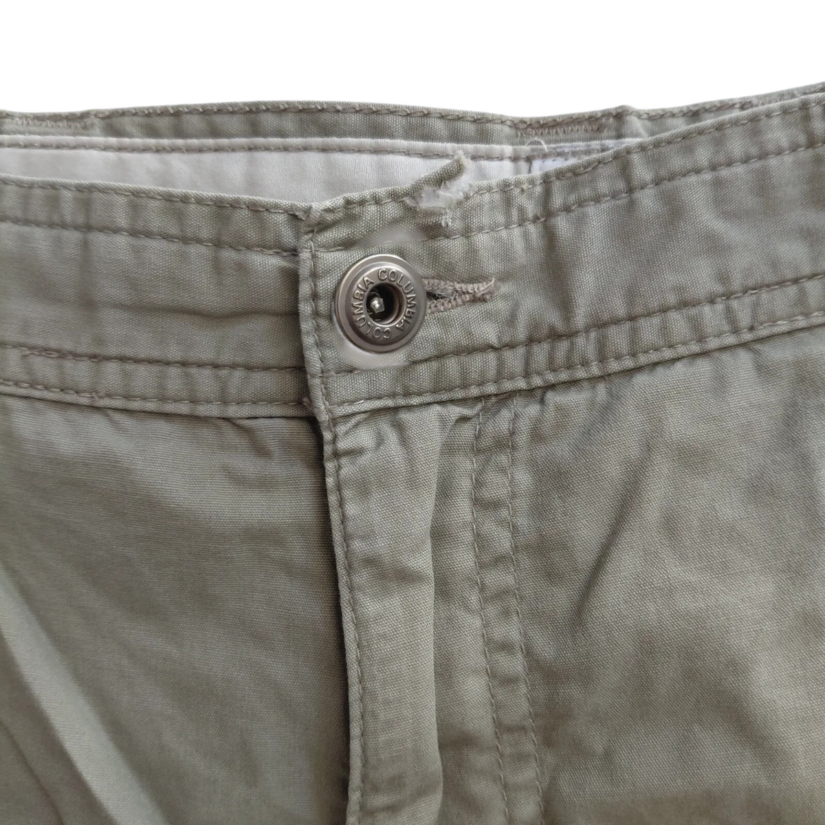 My Store beige Columbia cargo shorts featuring a branded metal button closure and durable cotton fabric.