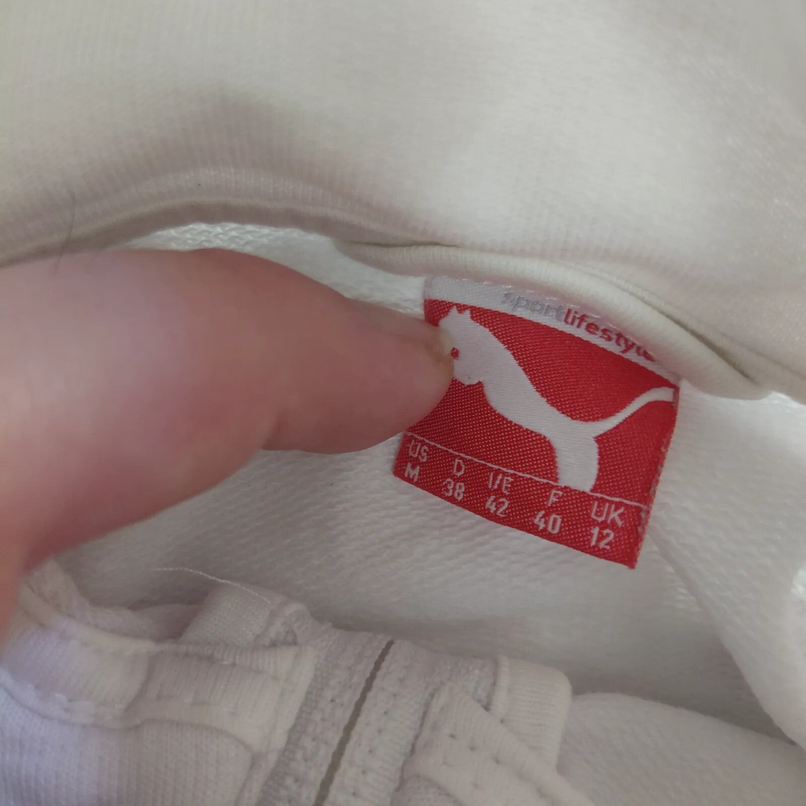My Store Puma white track jacket size label showing brand logo and sizing details