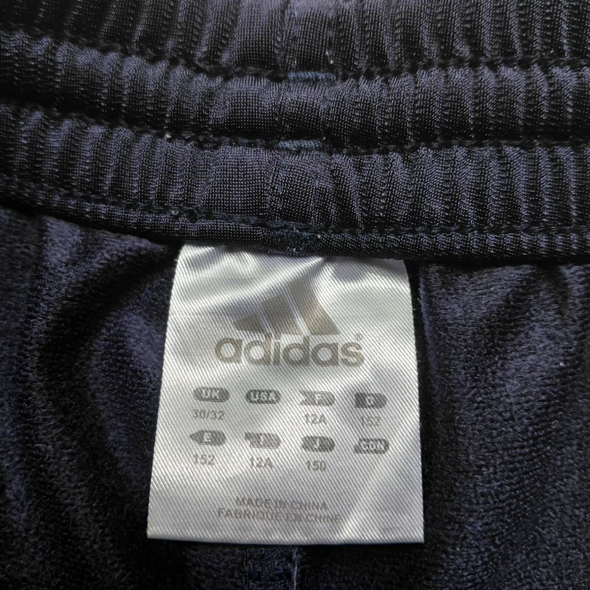 My Store Adidas navy blue polyester track pants size label with brand logo and care information