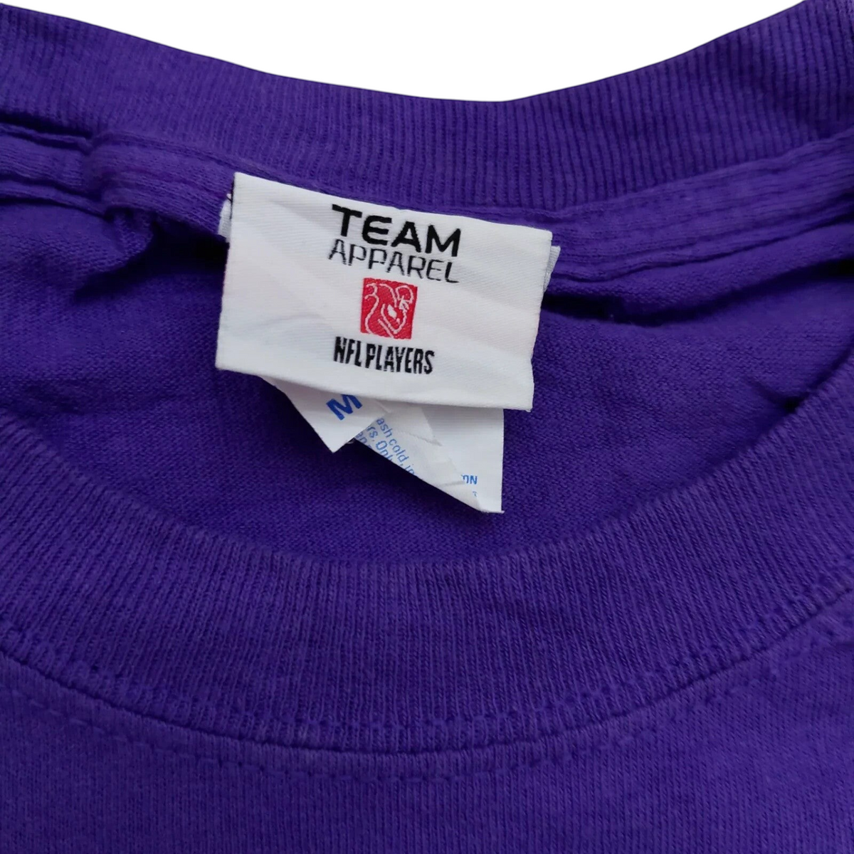 My Store Team Apparel purple Vikings NFL football t-shirt neck label showing size medium and NFL Players logo