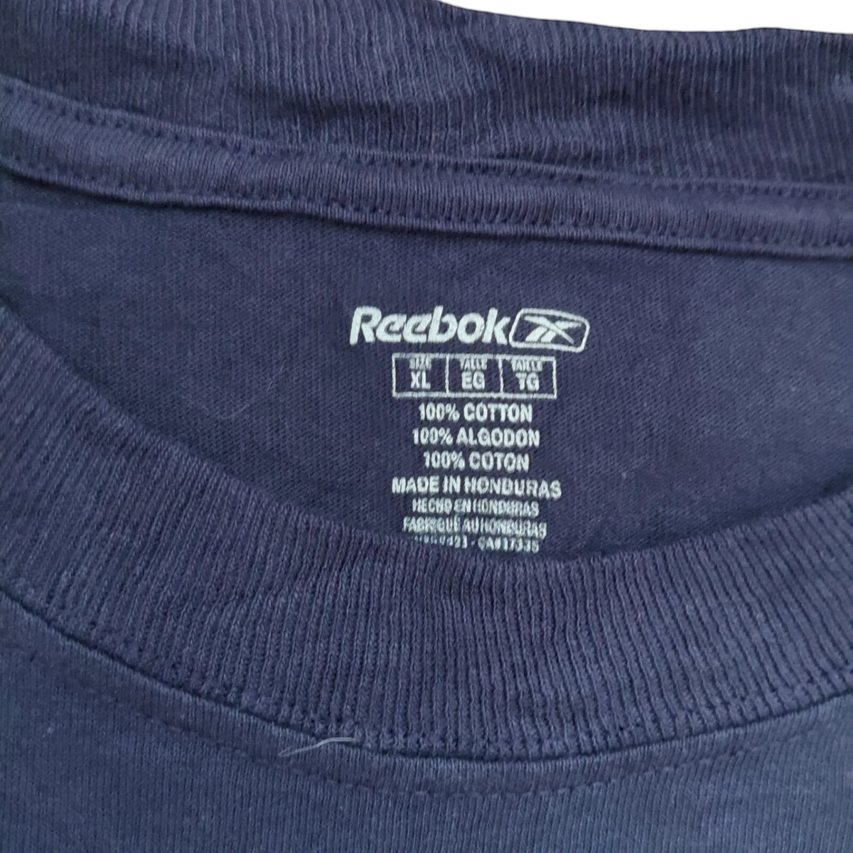 My Store Reebok navy blue cotton t-shirt interior neck label showing size XL and 100 percent cotton material