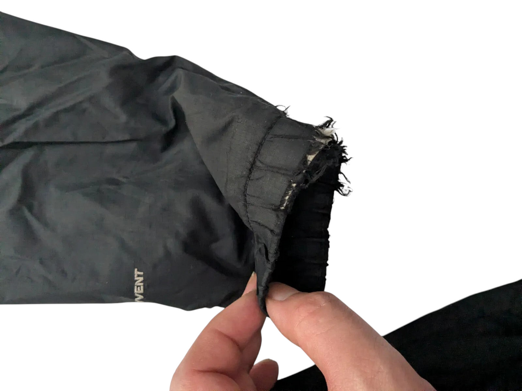 My Store The North Face womens black nylon ripstop shell jacket showing cuff wear and fabric separation