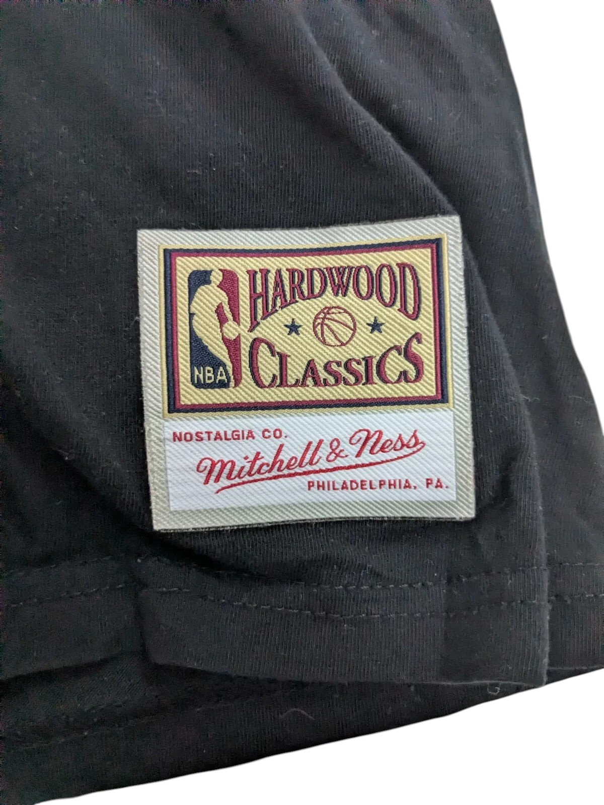 My Store Mitchell & Ness Hardwood Classics logo patch on a black cotton t-shirt